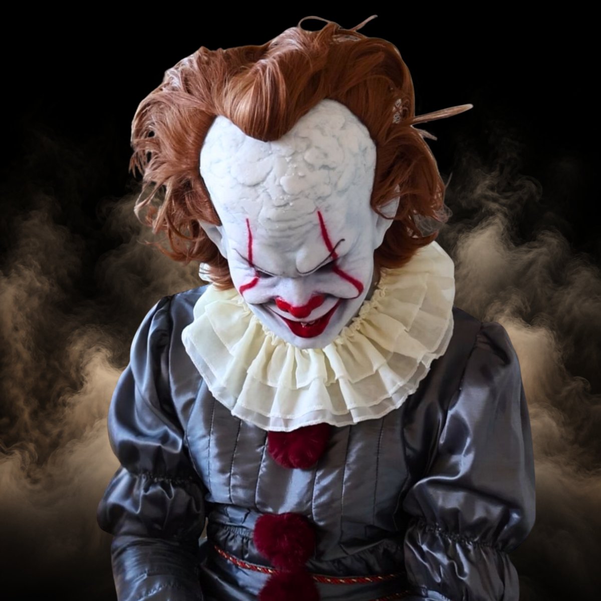 Orange hair clown mask worn with the grey costume and ruffled collar