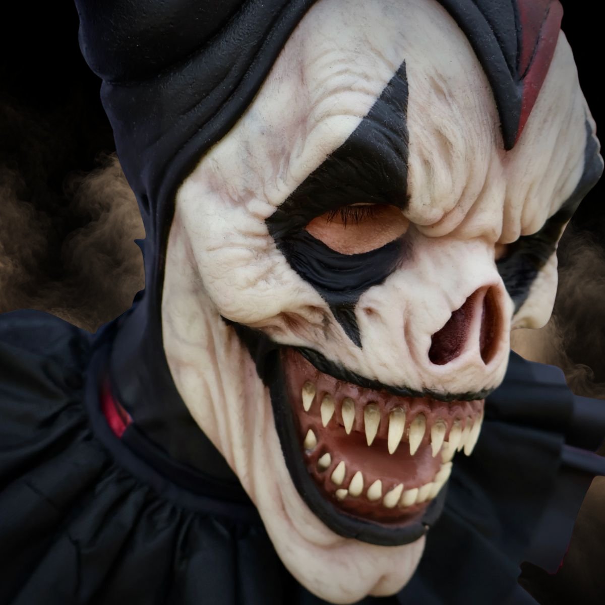 Three quarter view of a jester halloween mask under low light