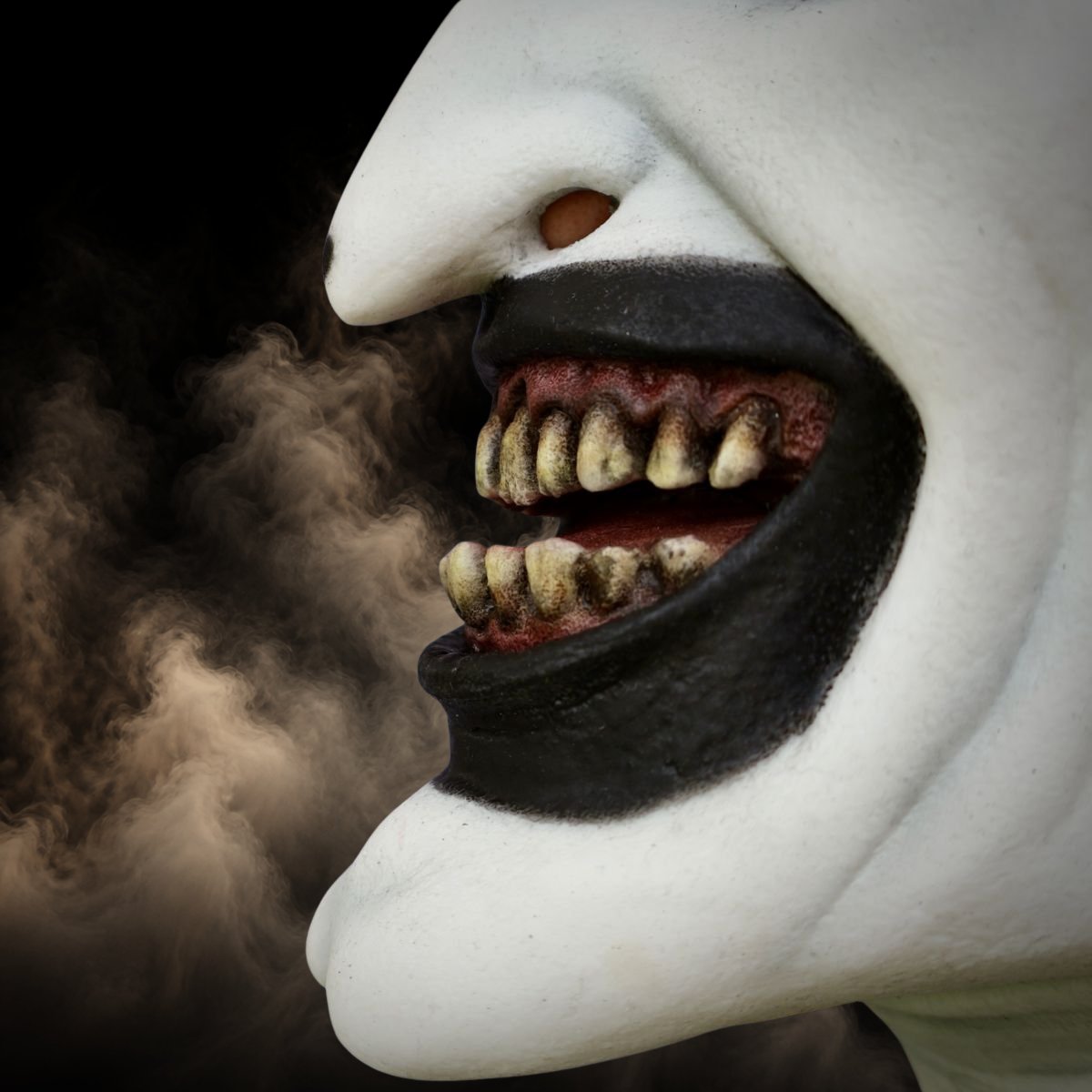 Close up of the yellowed teeth and painted lips on a scary clown mask